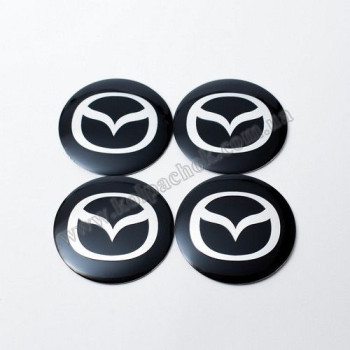 Наклейки для ковпачків на диски Mazda чорні/хром лого (54мм) Наклейки для ковпачків на диски Mazda чорні/хром лого (54мм)
