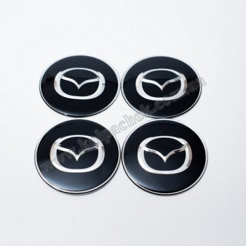 Наклейки для ковпачків на диски Mazda чорні/хром лого (65мм) Наклейки для ковпачків на диски Mazda чорні/хром лого (65мм)