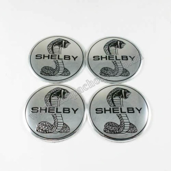 Наклейки для ковпачків на диски Shelby хром (56мм) Наклейки для ковпачків на диски Shelby хром (56мм)